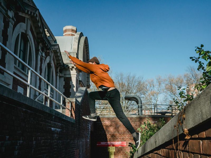 A man in mid-motion during a dynamic strength exercise.