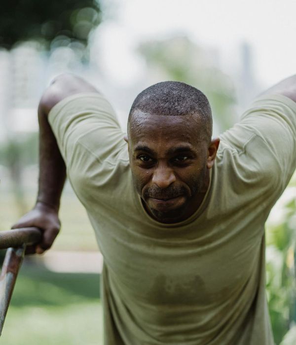 Man performing a controlled bodyweight exercise with intense focus.